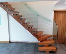 Modern Oak Staircase with Open Treads on Central Stringer with Glass Banisters and Glass Wall Handrail